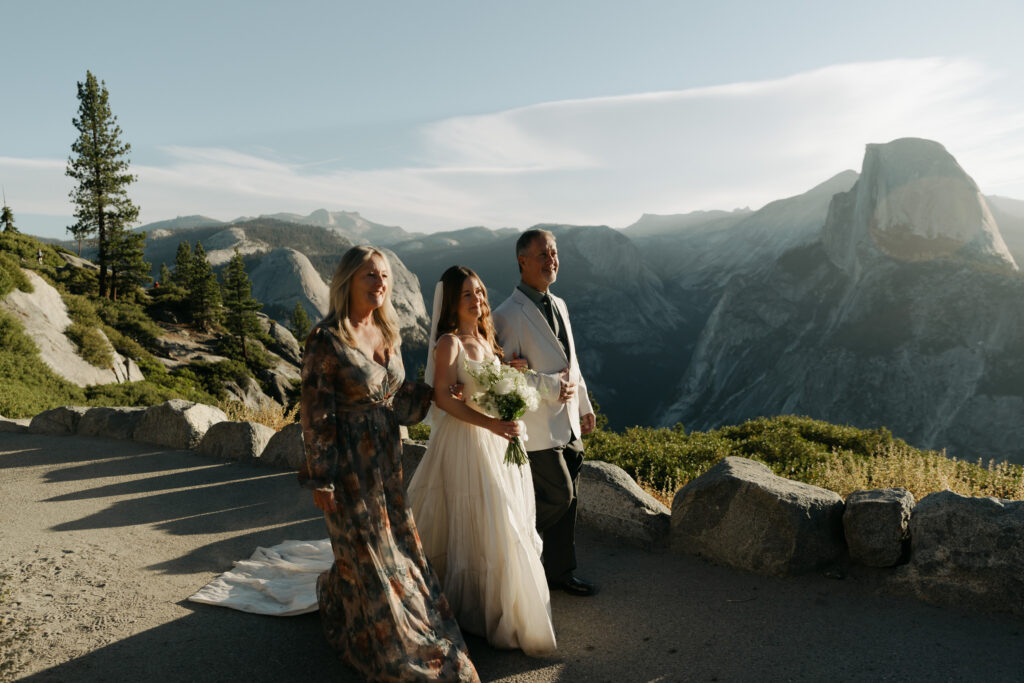 Bride walking with her parents after an intimate Glacier Point micro wedding ceremony in Yosemite National Park