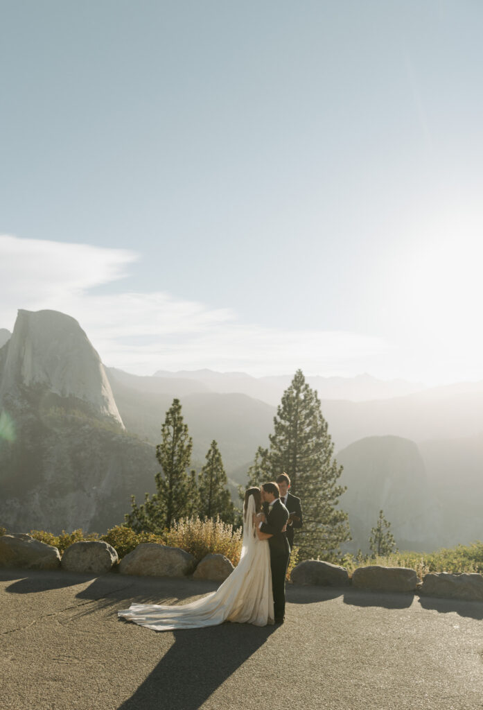 Newlyweds overlooking Half Dome after their sunrise Glacier Point wedding