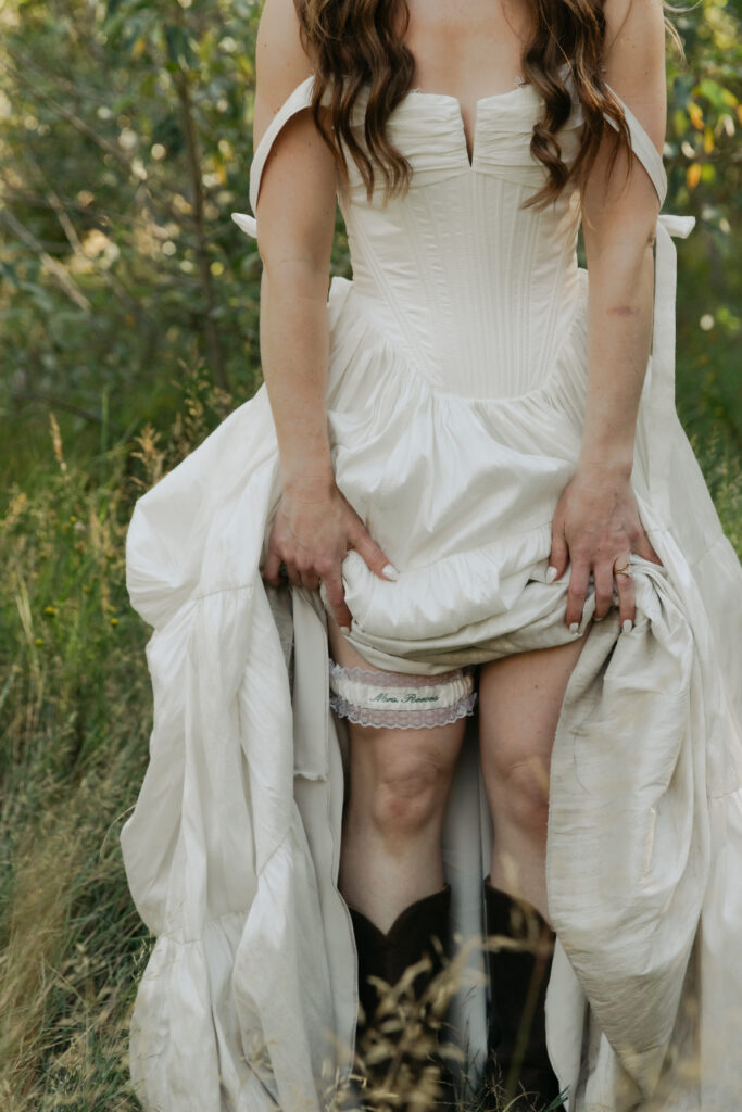 Bride showing her wedding dress and boots during playful Yosemite Valley portraits