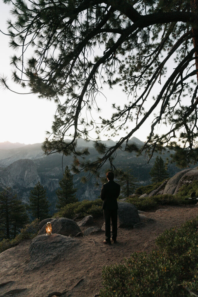 Groom waiting for his bride during a sunrise first look at Glacier Point in Yosemite National Park