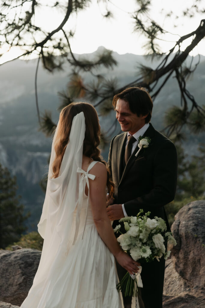 Bride and groom smiling together during their intimate Yosemite elopement at Glacier Point