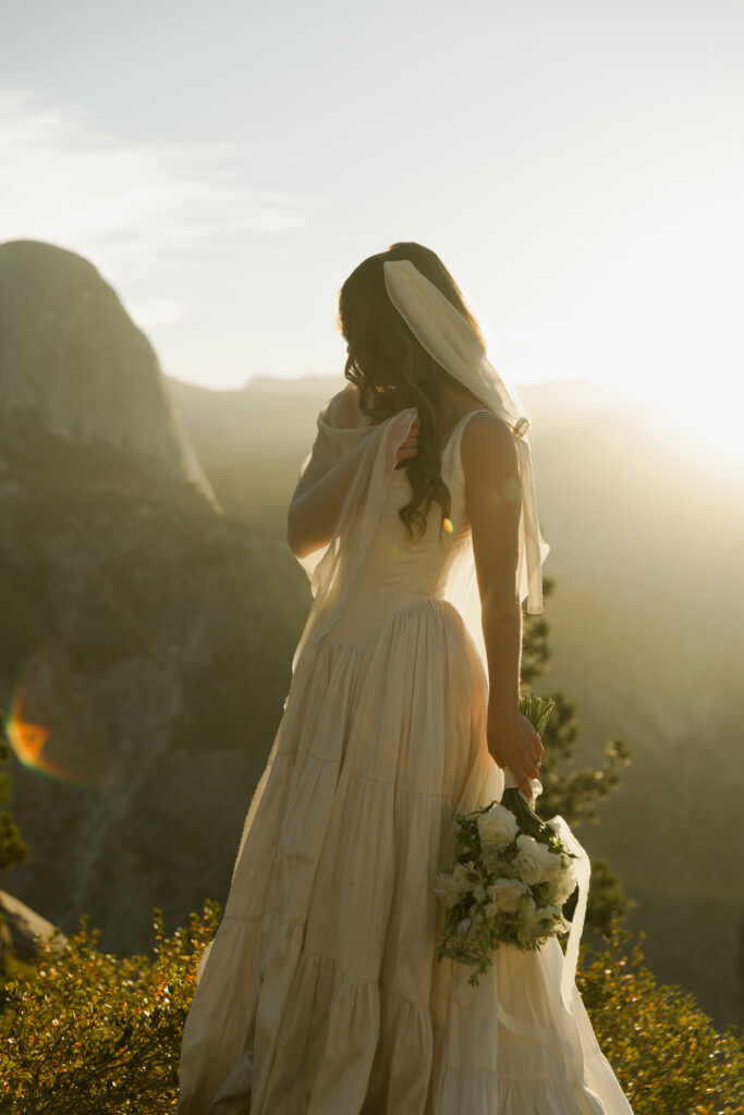 Bridal portrait overlooking Half Dome during a golden sunrise at Glacier Point